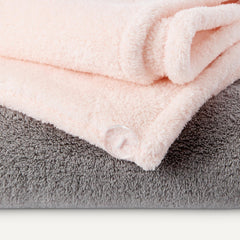 Amazon Basics towel wrapped on hair in bathroom demonstrating secure fit