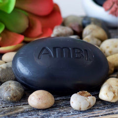 Ambi black soap in use washing face illustrating soft skin results