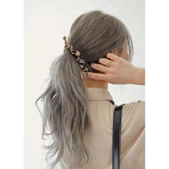 AMCAMI styled in half-up hairstyle lifestyle image showing polished appearance