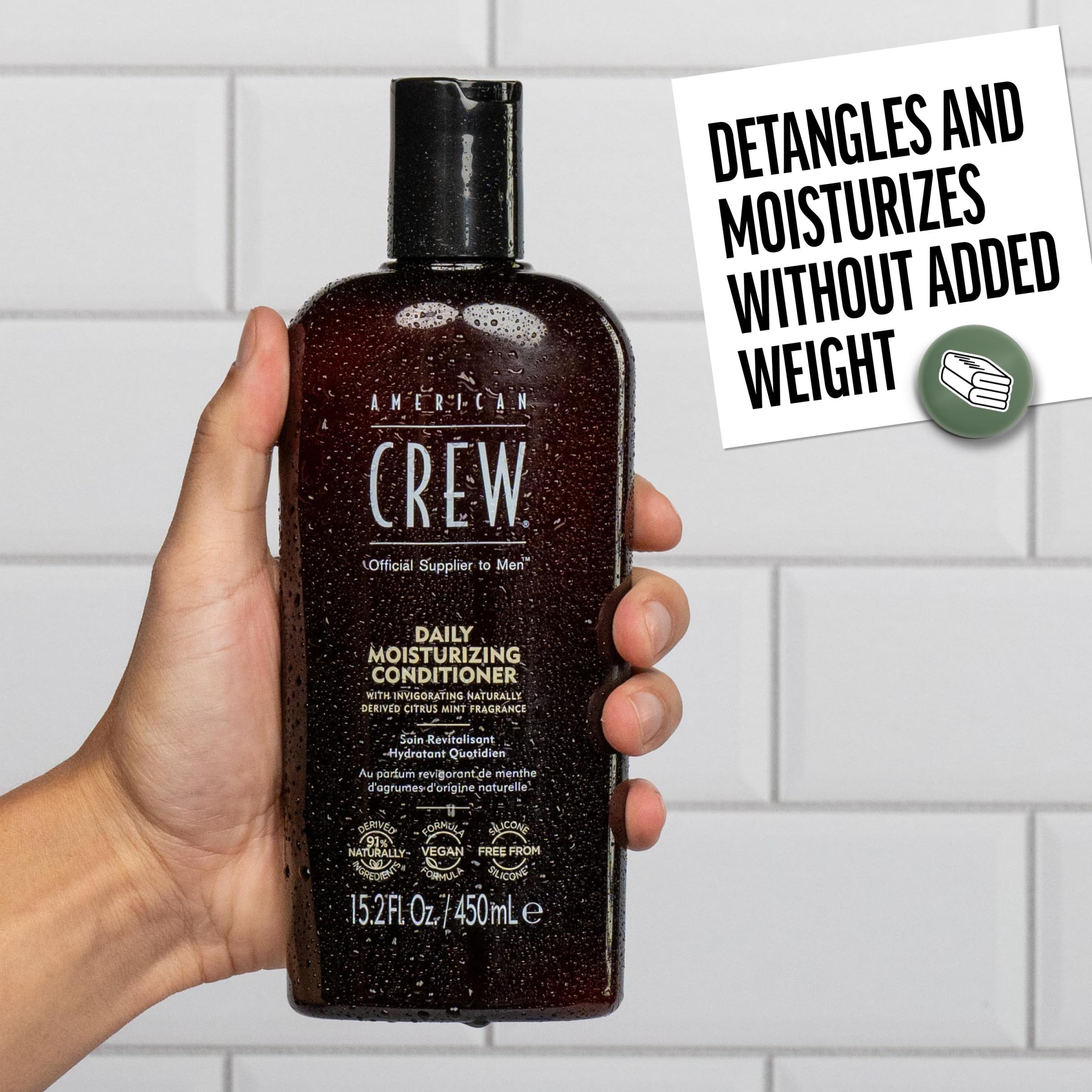 American Crew conditioner being massaged into wet hair in shower for effortless detangling benefit
