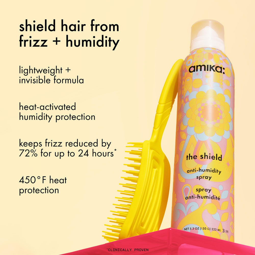 amika the shield spray held in hand demonstrating heat protection