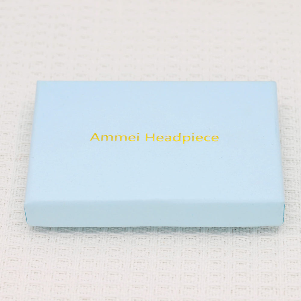 Ammei Headpiece next to coin showing scale and lightweight size for comfort