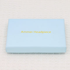 Ammei Headpiece next to coin showing scale and lightweight size for comfort