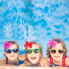 AMYDECOR bow worn poolside as a water-friendly accessory for summer fun