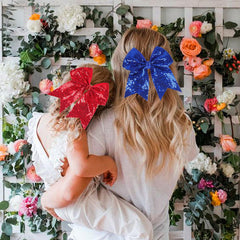 AMYDECOR bow held in hand for scale showing true 7-inch size