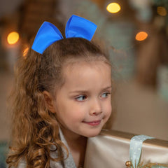 AMYDECOR bow held in hand showing scale and size benefit: clear 5-inch measurement