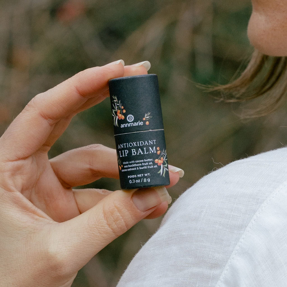 annmarie lip balm on hand during application for instant hydration