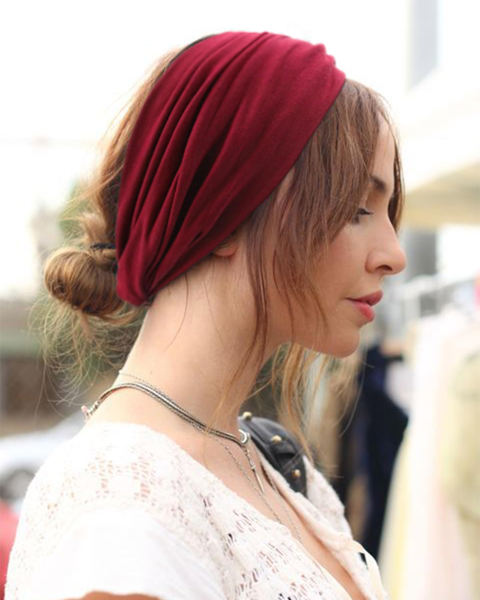 AQOKKA headband held in hand to show scale and stretchability for accurate sizing