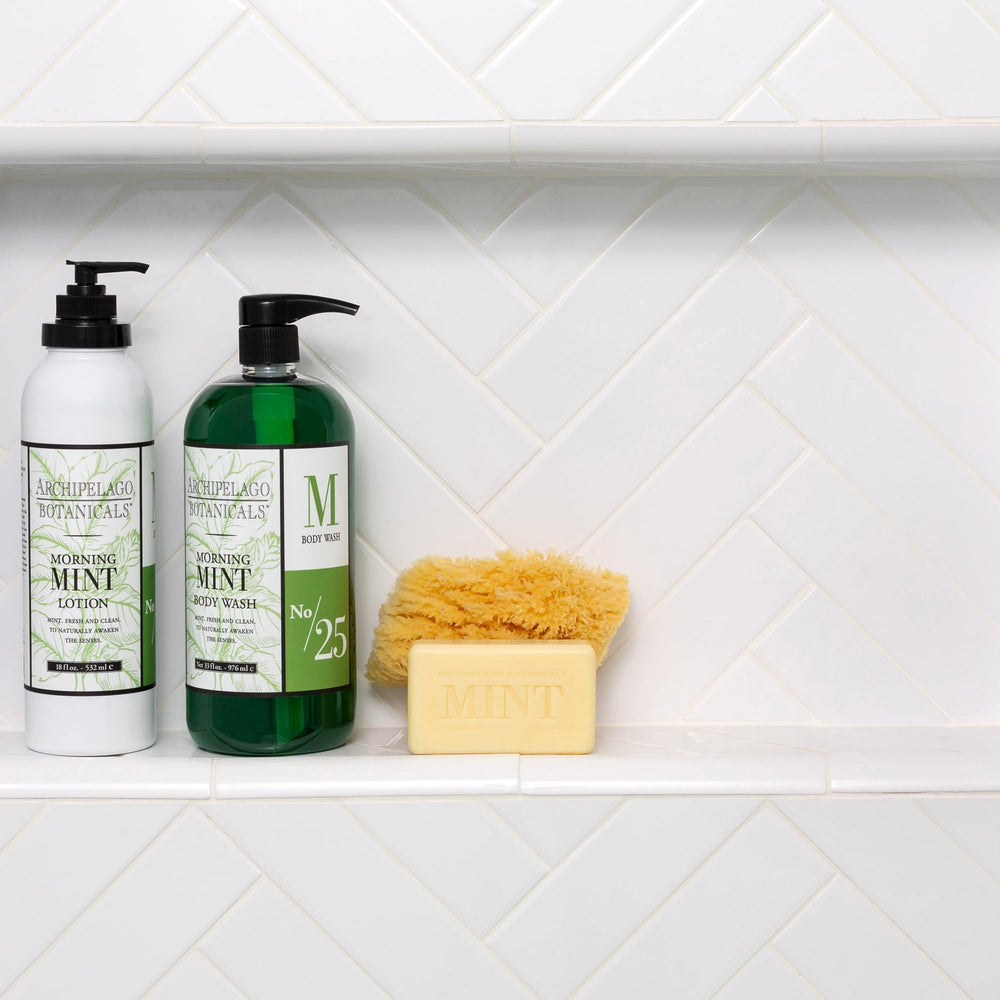 Archipelago Botanicals bottle in hand under shower illustrating in-use refreshment and sensory benefit