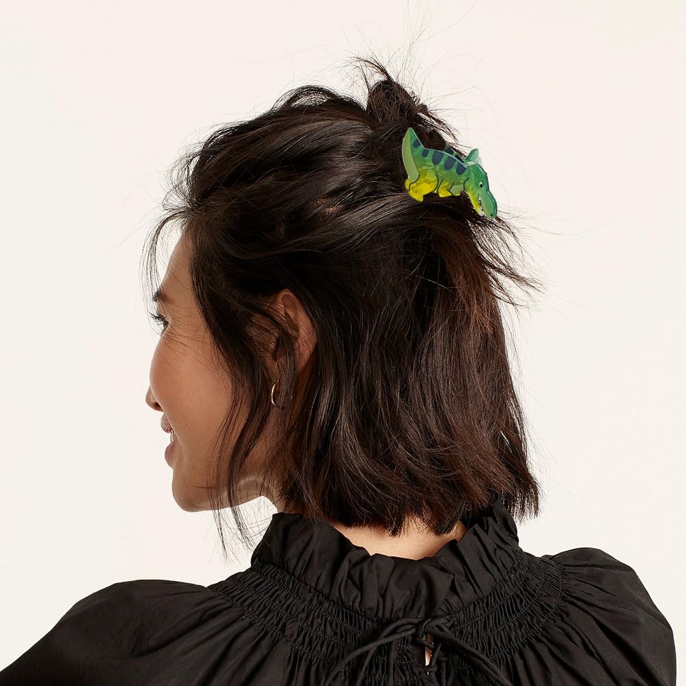Arvintas clip holding a half-up hairstyle, adds playful Y2K accent