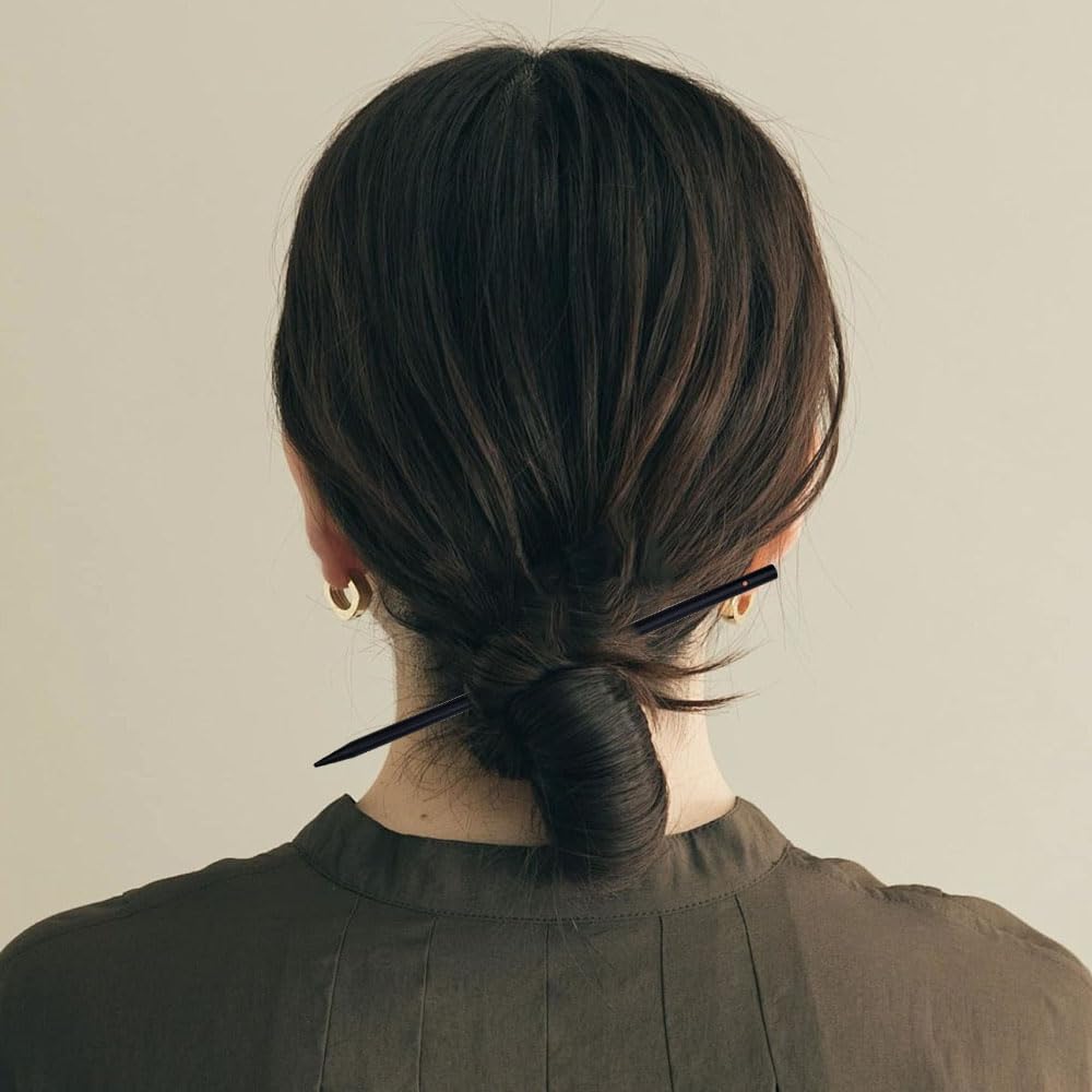 arvintas hair stick beside coin showing scale and lightweight portability