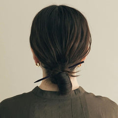 arvintas hair stick beside coin showing scale and lightweight portability