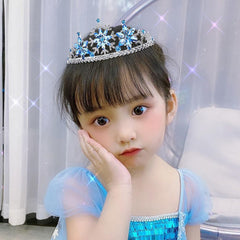 Arvintas tiara beside a hand for scale showing compact, lightweight crown