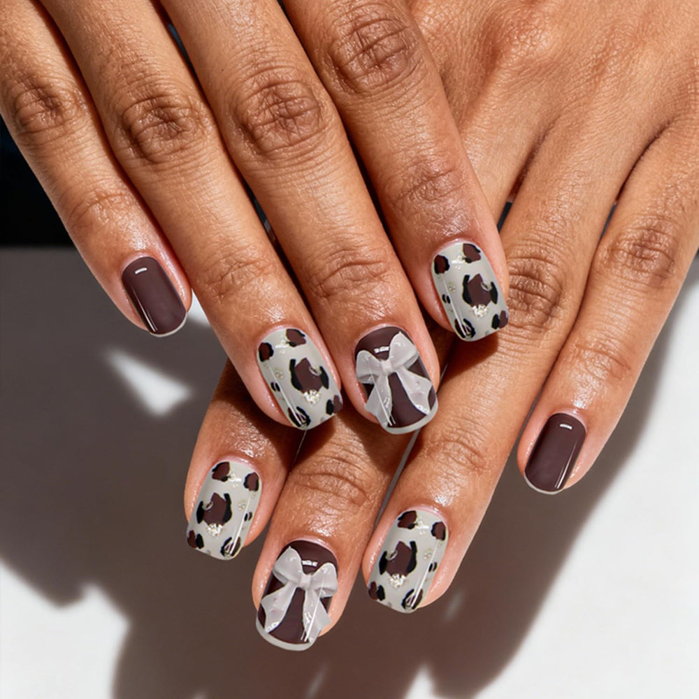 Ashowner finished manicure on hands showcasing salon-quality glossy results