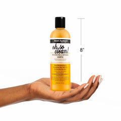 Aunt Jackie's 12 oz bottle next to ruler conveying accurate size and value benefit
