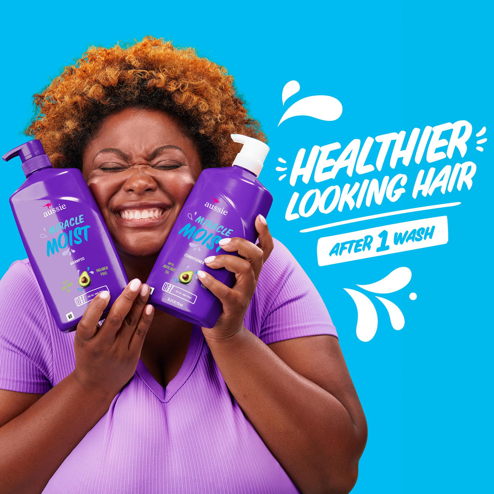Aussie lathered hair in shower showing slip for detangling and softening benefit