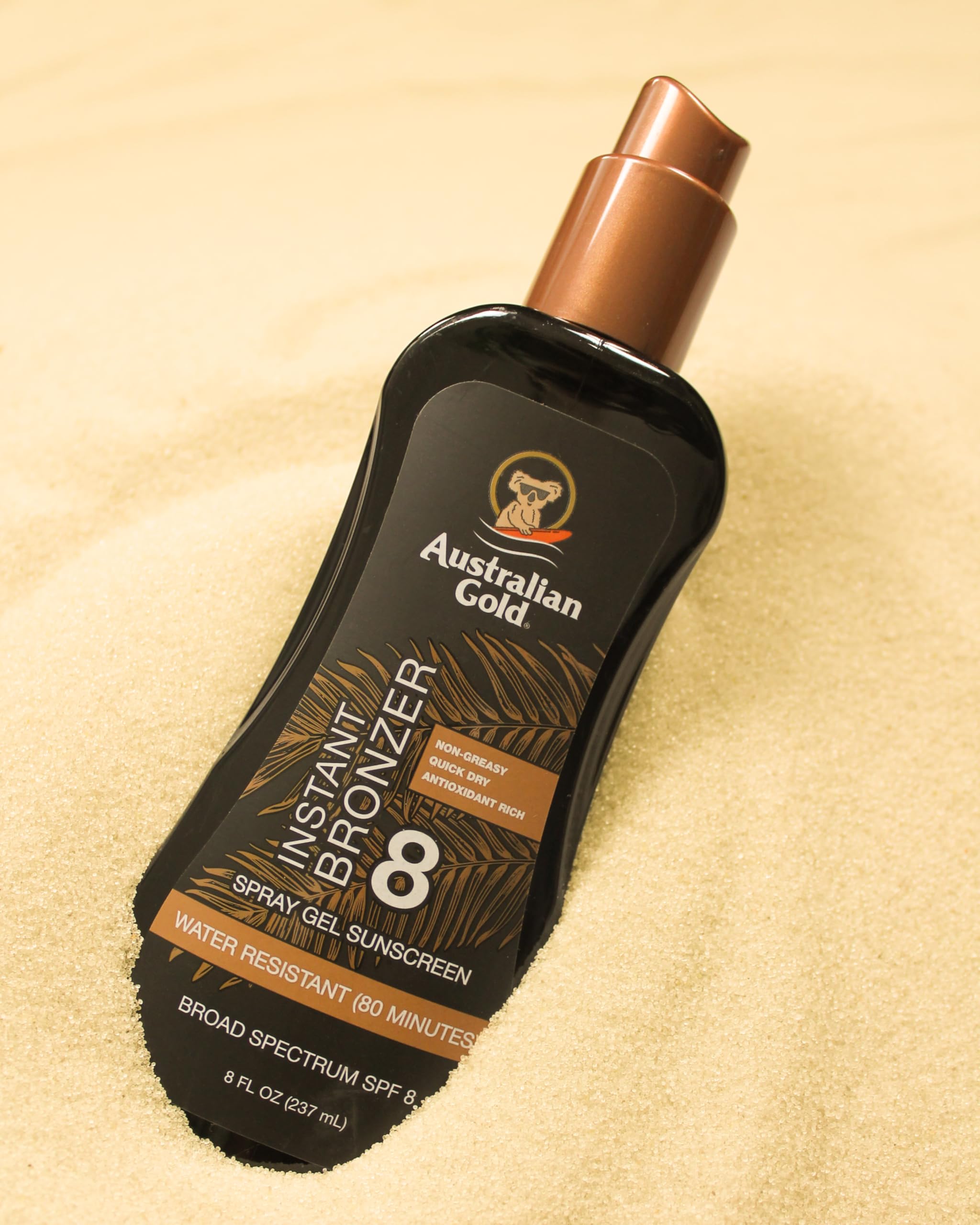 Australian Gold spray in use on an arm demonstrating even application and quick tint