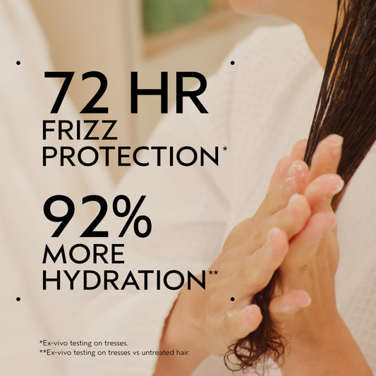 Aveda Be Curly close-up texture on fingertips, demonstrates creamy hydrating slip
