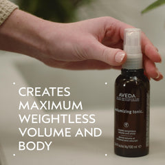 Aveda volumizing tonic spraying fine mist demonstrating easy root application benefit