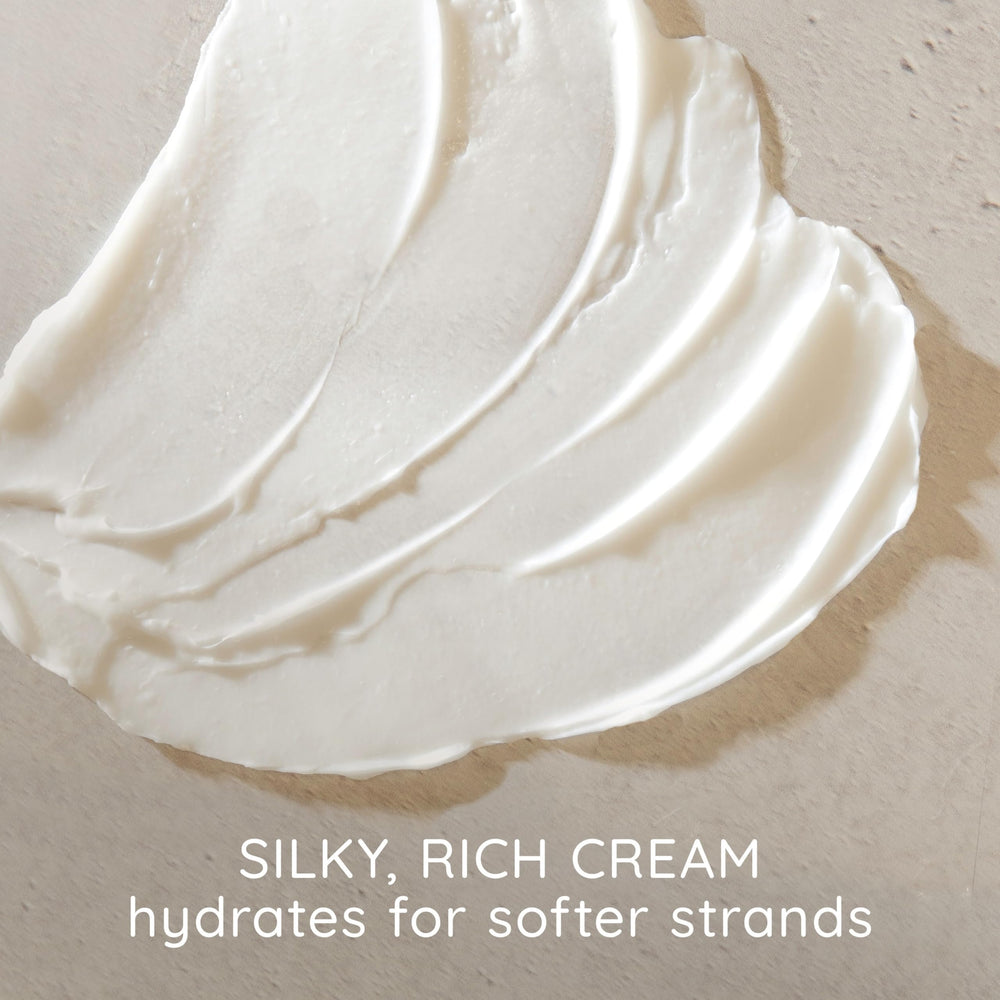 aveeno creamy conditioner texture on hand showing moisturizing slip