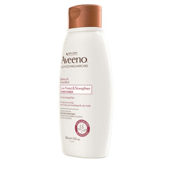 Aveeno 12 fl oz bottle held for size comparison showing travel-friendly volume