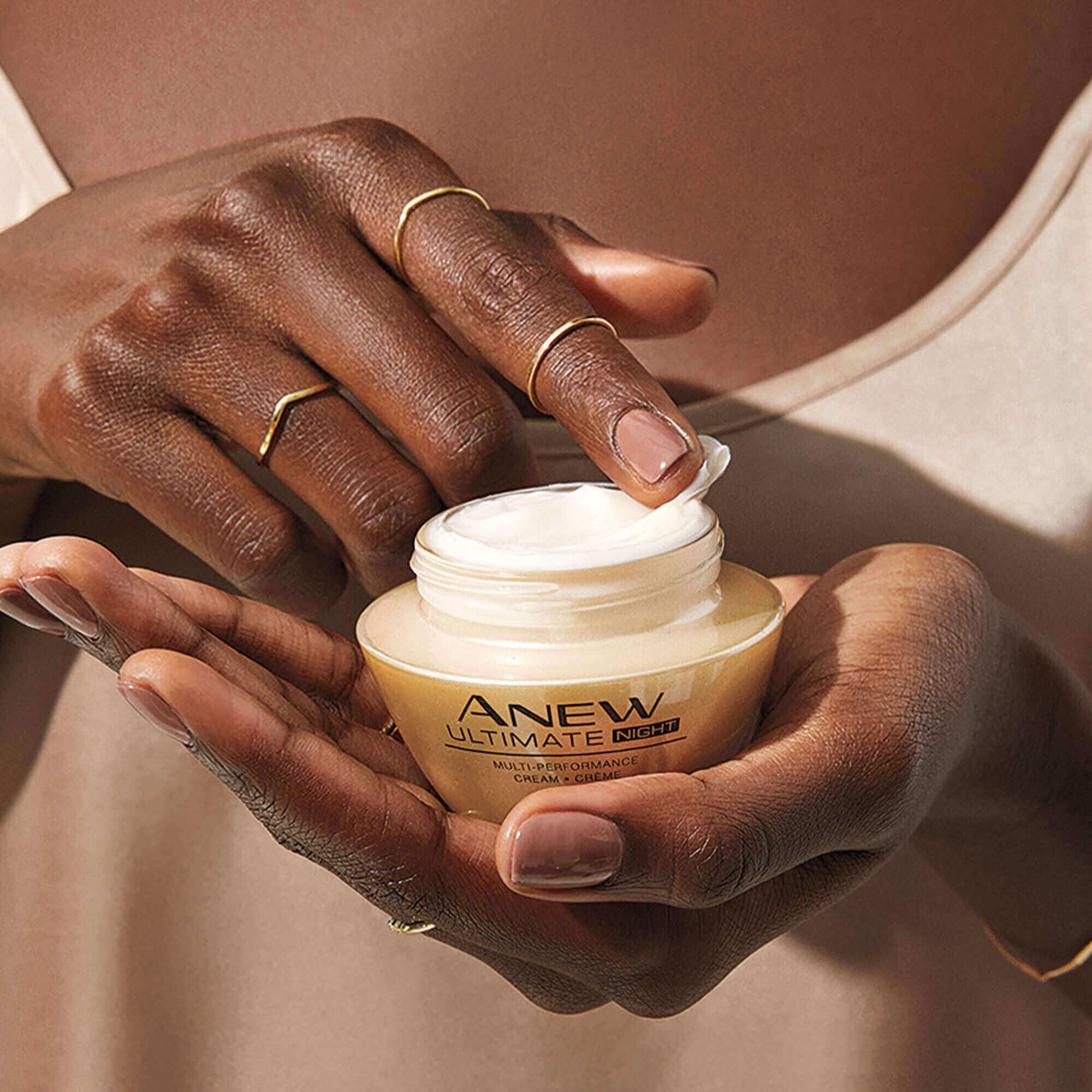 AVON night cream on fingertip demonstrating easy application and spread