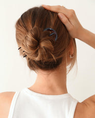 AWAYTR hair pins in hand indicate compact size and travel-friendly convenience