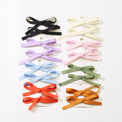 Ayesha front packaging showing 16 satin bow clips and color options for easy selection
