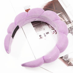 Ayesha headband next to a ruler showing size comparison benefit: one-size-fit flexibility
