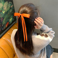 Ayesha bow clipped in ponytail demonstrating secure hold and elegant tail movement