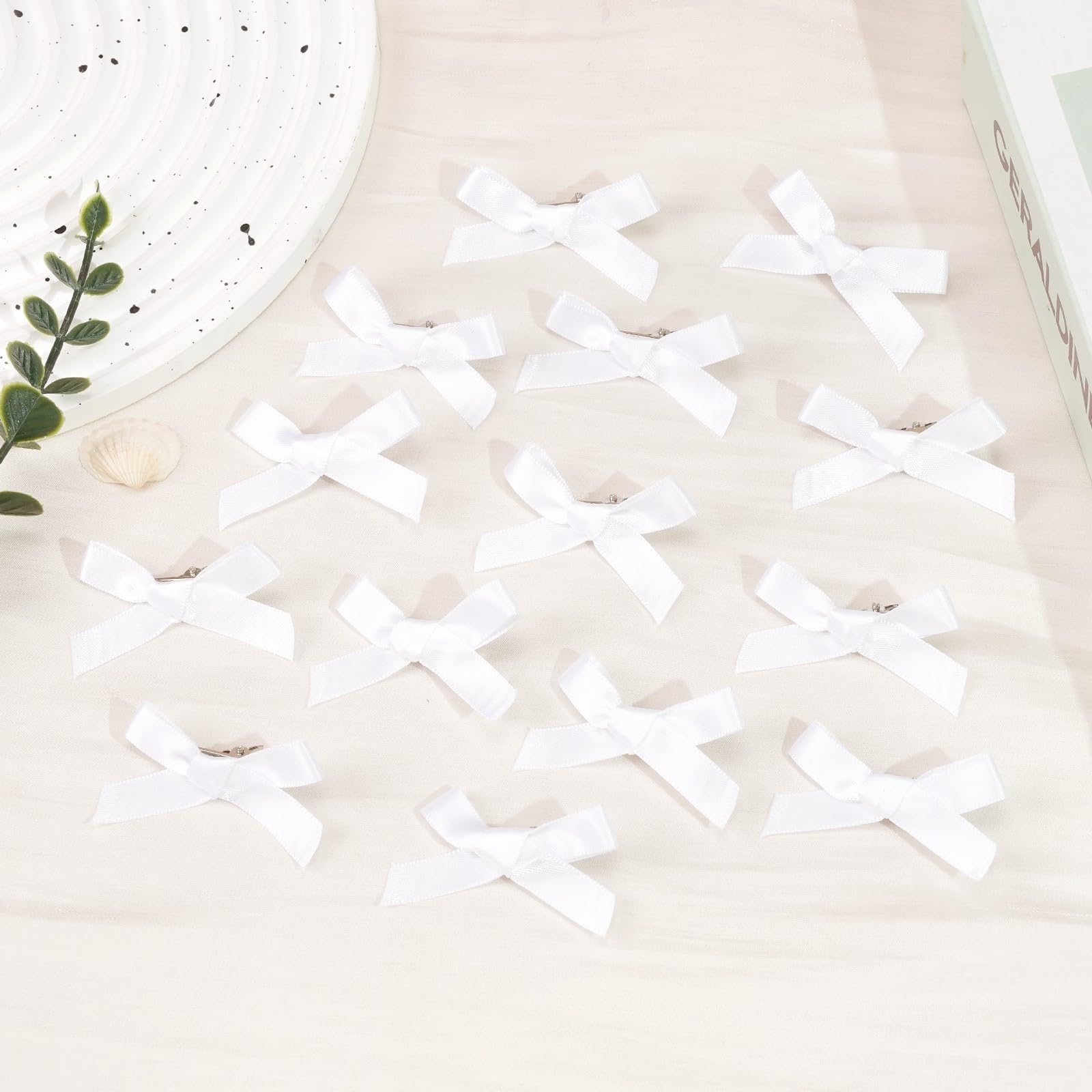 Ayesha bow size comparison in hand to show compact 2-inch scale