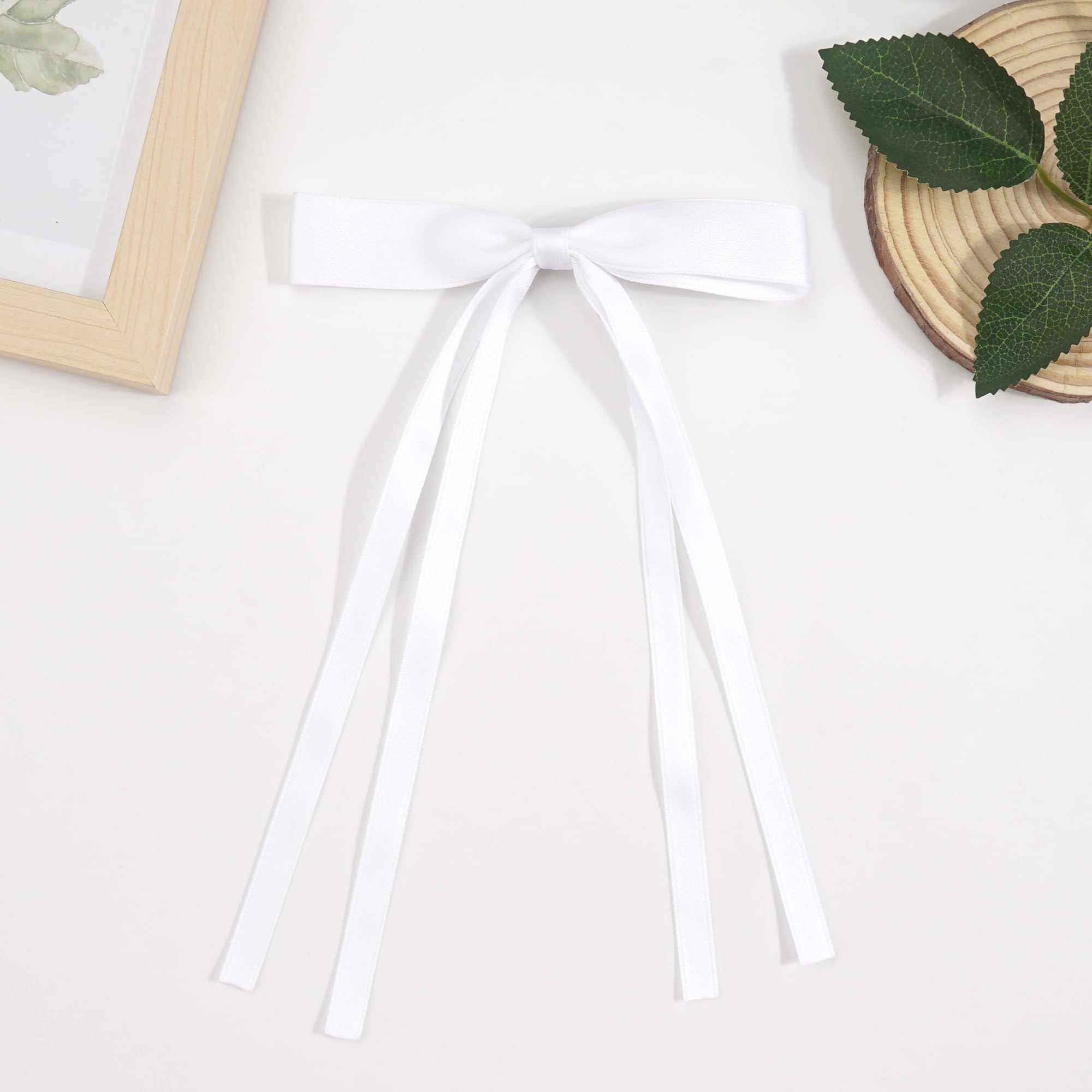 Ayesha bow held in hand showing true size and proportion for gifting