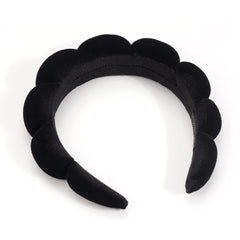 Ayesha headband held in hand demonstrating size and lightweight portability benefit