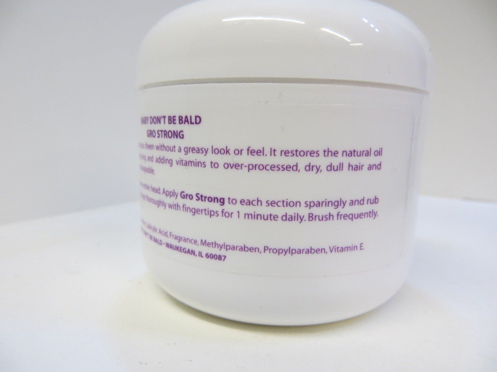 Baby Don't Bald parent applying serum to baby's scalp for gentler detangling