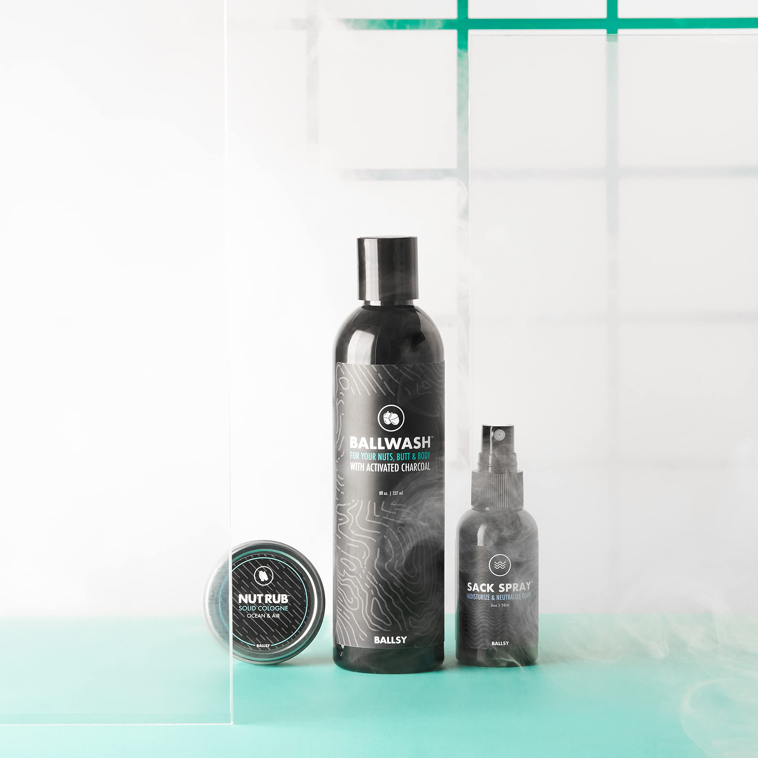 Ballsy Ballwash next to a toothbrush for scale showing compact 8 oz travel-friendly size