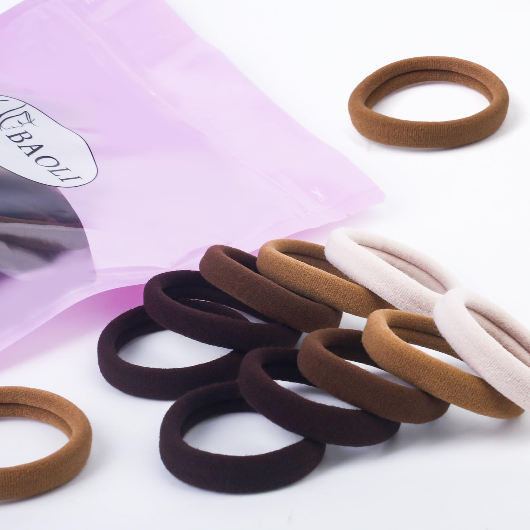 BAOLI hair tie next to a ruler showing 2-inch diameter for scale and reliable fit benefit