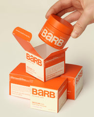 The Barb Shop 2 oz jar next to everyday items showing compact size and travel-friendly benefit