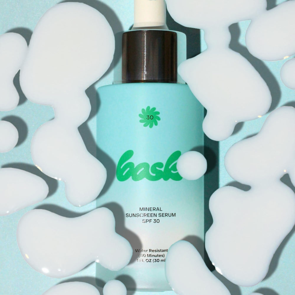 Bask 1 oz bottle next to coin showing compact travel size