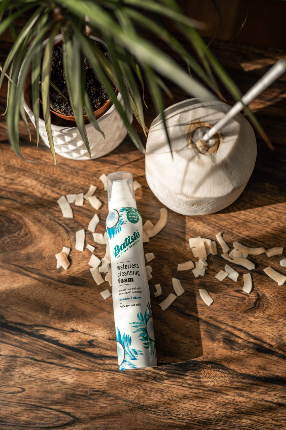 Batiste can next to hand showing 3.6 oz travel-ready sizing benefit