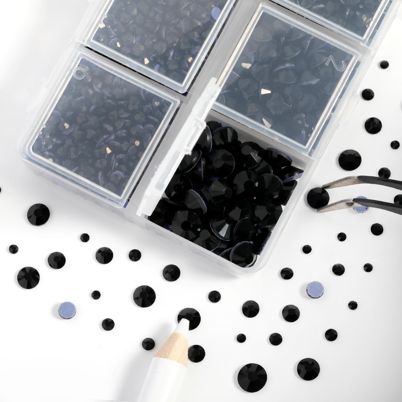 BEADSLAND tweezers and wax pencil placing a rhinestone showing precise placement benefit