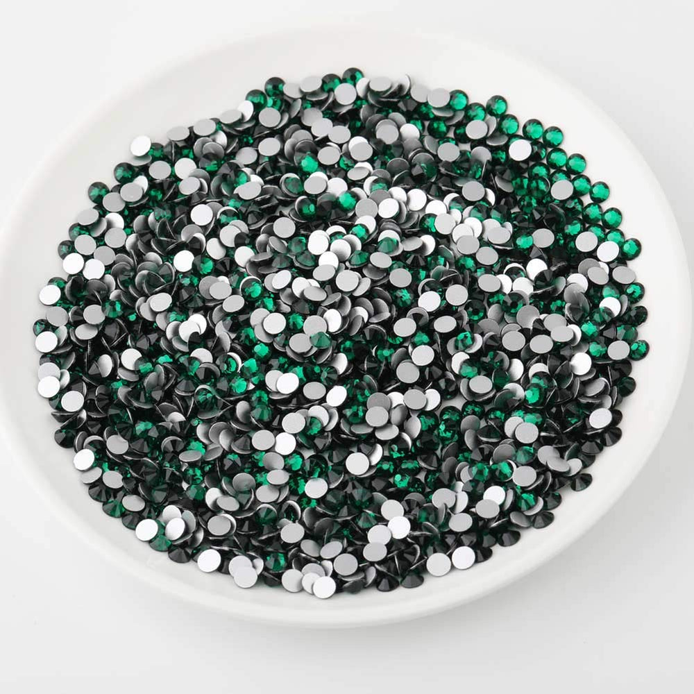 BEADSLAND rhinestone applied on a nail design giving jewel-tone focal sparkle