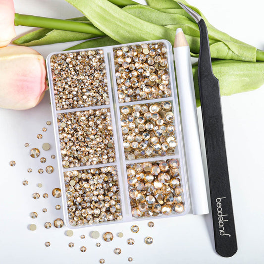 BEADSLAND close-up of mixed-size golden shadow rhinestones highlighting precise facets and shine