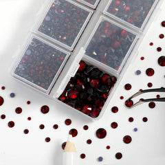 BEADSLAND rhinestones being applied to a jacket with tweezers and wax pencil for precise placement