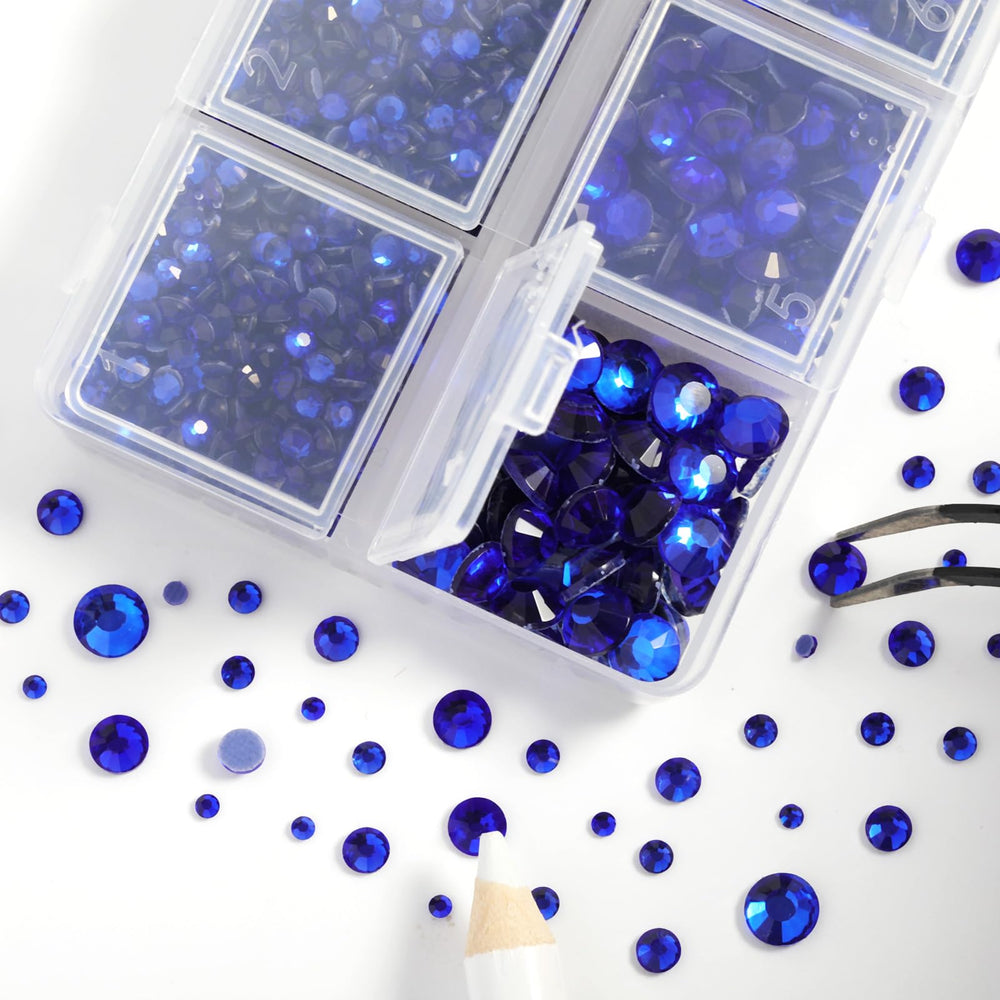 BEADSLAND rhinestones being heat-applied to a dress with tweezers and iron for secure adhesion