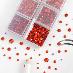 BEADSLAND tweezers and wax pencil picking a rhinestone for precise placement benefit