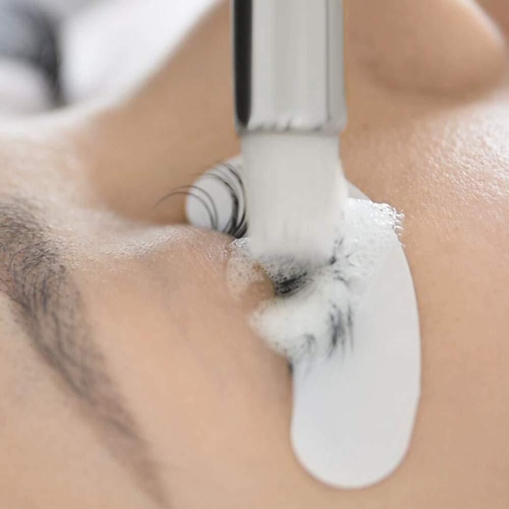 BEAU LASHES in-salon application showing technician cleaning extensions for longer retention