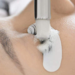 BEAU LASHES in-salon application showing technician cleaning extensions for longer retention