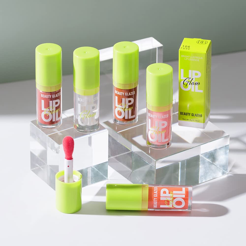 Beauty Glazed lip oil beside purse on table showing everyday portability
