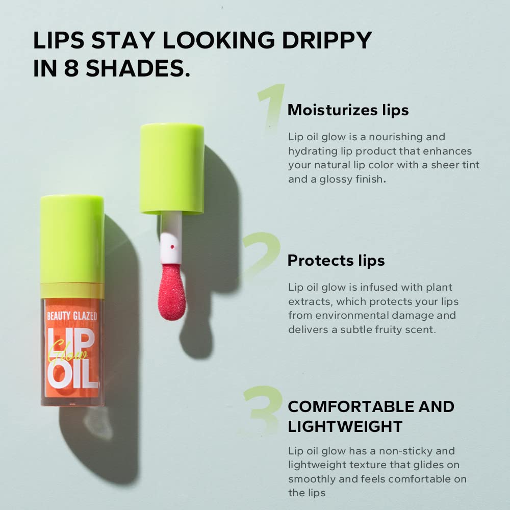Beauty Glazed lip oil held by fingers showing compact size and control