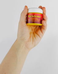 Beesaluxe Buckderma ingredient flatlay with seabuckthorn and oils highlighting natural formulation benefit